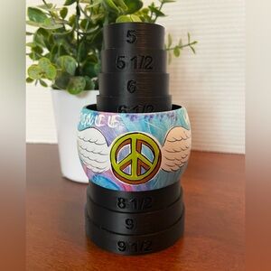 Bangle Bracelet. Approximately 2” Wide With Peace Signs And Wings Design. NWOT